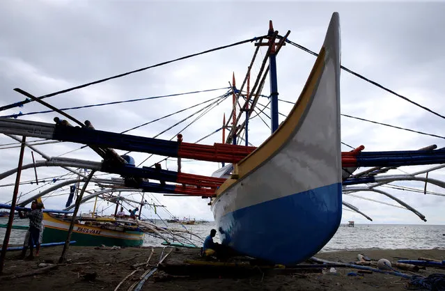 Workers inspects a fishing boat being repaired in a coastal village in Infanta town, Pangasinan province, north west of Manila, Philippines July 6, 2016. (Photo by Romeo Ranoco/Reuters)