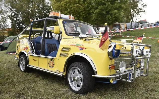 Peter Goebel sits in his 40 horsepower engine Trabant Tramp as fans of the East German Trabant car gather for their 7th annual get-together on August 23, 2014 in Zwickau, Germany. Hundreds of Trabant enthusiasts arrived to spend the weekend admiring each others cars, trading stories and enjoying activities. The Trabant, dinky and small by modern standards, was the iconic car produced in former communist East Germany and today has a strong cult following. (Photo by Matthias Rietschel/Getty Images)