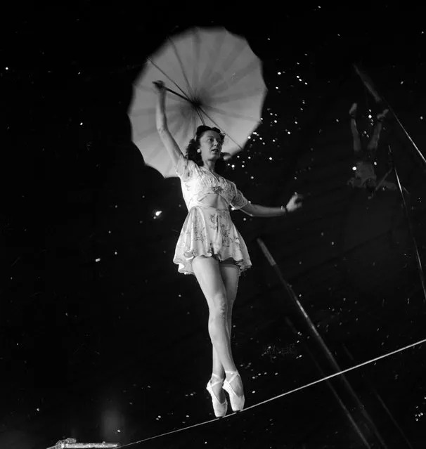 An acrobat holding an umbrella and rehearsing on a rope for the Ringling Bros. and Barnum & Bailey Circus in Sarasota, FL in 1949. (Photo By Nina Leen/Time Life Pictures/Getty Images)
