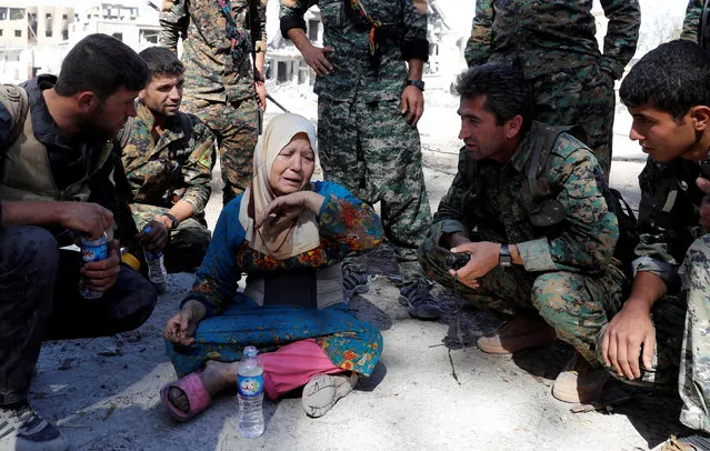 A woman cries after she was rescued by fighters of Syrian Democratic Forces at the stadium after Raqqa was liberated from the Islamic State militants, in Raqqa, Syria October 17, 2017. (Photo by Erik De Castro/Reuters)