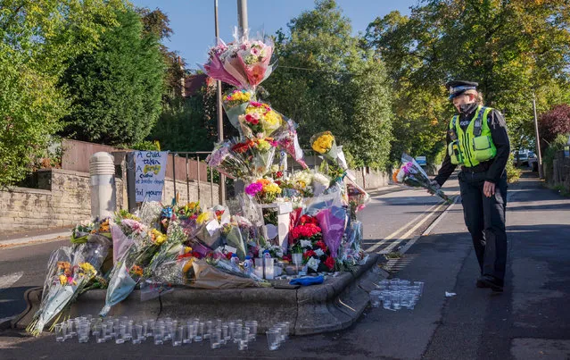 A police community support officer lays a floral tribute at the scene in Woodhouse Hill, Huddersfield, UK on Friday, September 23, 2022, where 15-year-old schoolboy Khayri McLean was fatally stabbed outside his school gates. (Photo by Danny Lawson/PA Images via Getty Images)