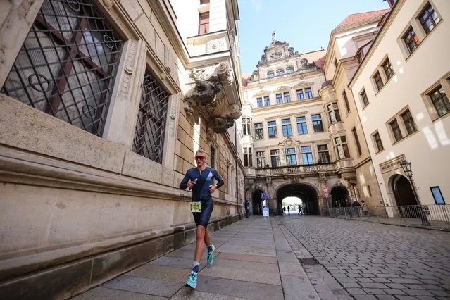 Image has been digitally enhanced) Athletes perform in the run leg during the  IRONMAN 70.3 Dresden on September 18, 2022 in Dresden, Germany. (Photo by Joern Pollex/Getty Images for IRONMAN)