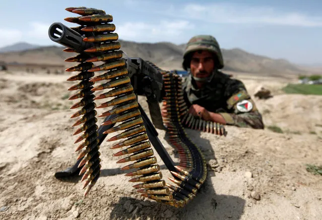 An Afghan National Army soldier holds a position while patrolling the village of But Khak on the outskirts of Kabul May 15, 2012. (Photo by Omar Sobhani/Reuters)