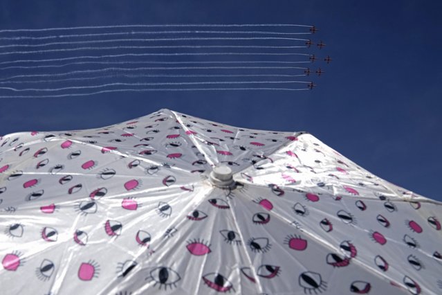 Indian Air Force's aerobatic team Suryakiran perform maneuvers on the third day of the Aero India 2025, a biennial event, at Yelahanka air base in Bengaluru, India, Wednesday, February 12, 2025. (Photo by Aijaz Rahi/AP Photo)