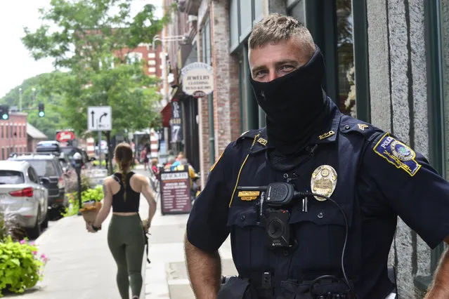 Brattleboro, Vt., Police Officer Jason Hamilton patrols around Brattleboro while wearing a mask on Friday, July 24, 2020. Vermont Gov. Phil Scott said in a press conference that starting Aug. 1, masks will be mandatory in public. (Photo by Kristopher Radder/The Brattleboro Reformer via AP Photo)