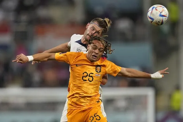 Walker Zimmerman of the United States, background, and Jeremie Frimpong of the Netherlands jump for the ball during the World Cup round of 16 soccer match between the Netherlands and the United States, at the Khalifa International Stadium in Doha, Qatar, Saturday, December 3, 2022. (Photo by Martin Meissner/AP Photo)