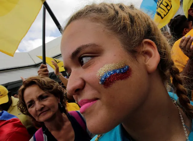 A opposition supporter with her face painted with the colors of Venezuela's flag is seen as she takes part in a rally to demand a referendum to remove Venezuela's President Nicolas Maduro, in Los Teques near Caracas, Venezuela, September 7, 2016. (Photo by Henry Romero/Reuters)