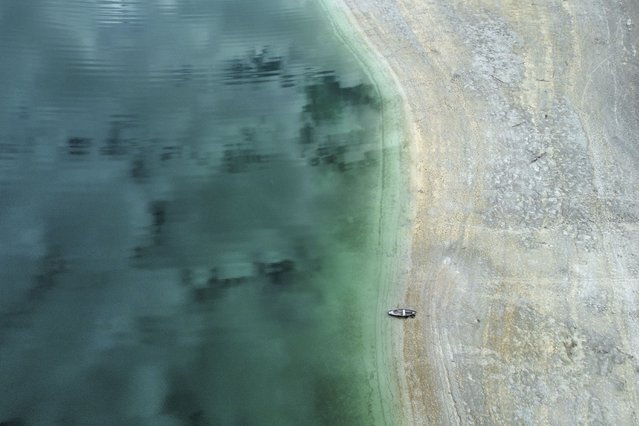 A boat lies at the lake Walchensee during low water near Garmisch-Partenkirchen, Germany, Tuesday, April 22, 2025. (Photo by Matthias Schrader/AP Photo)
