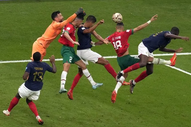 Morocco's Jawad El Yamiq, second right, fights for the ball with France's Raphael Varane, third right, and Randal Kolo Muani, right, during the World Cup semifinal soccer match between France and Morocco at the Al Bayt Stadium in Al Khor, Qatar, Wednesday, December 14, 2022. (Photo by Thanassis Stavrakis/AP Photo)