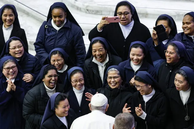 Pope Francis talks with nuns during the weekly General Audience in the Paul VI Audience Hall, in Vatican City, 21 December 2022. (Photo by Fabio Frustaci/EPA/EFE)