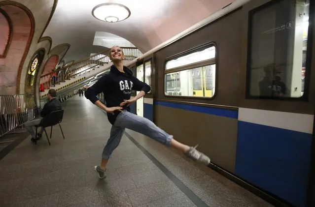 A dancer of the Kremlin Ballet theatre warms up before an overnight performance, staged to coincide with the ongoing FIFA Confederations Cup Russia 2017, at Novoslobodskaya metro station in Moscow, Russia on June 26, 2017. (Photo by Sergei Karpukhin/Reuters)
