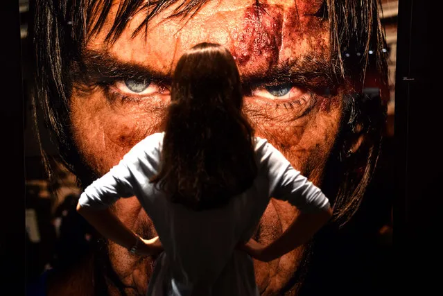 A visitor stands in front of a portrait taken by artist Bruce Gilden at the “Masters of Photography” exhibition at the Photokina trade fair in Cologne on September 20, 2016. The fair for the photographic and imaging sector, that is running from September 20 to 25, 2016, presents products from image capture, image processing and storage to image output. Photokina also includes a program of events with congresses, workshops, symposiums and photography exhibitions. (Photo by Patrik Stollarz/AFP Photo)