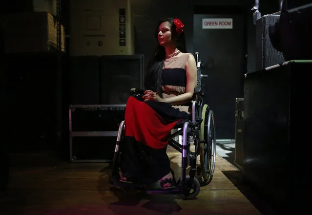 A competitor watches a performance from backstage during the Miss Wheelchair India beauty pageant in Mumbai November 26, 2014. (Photo by Danish Siddiqui/Reuters)
