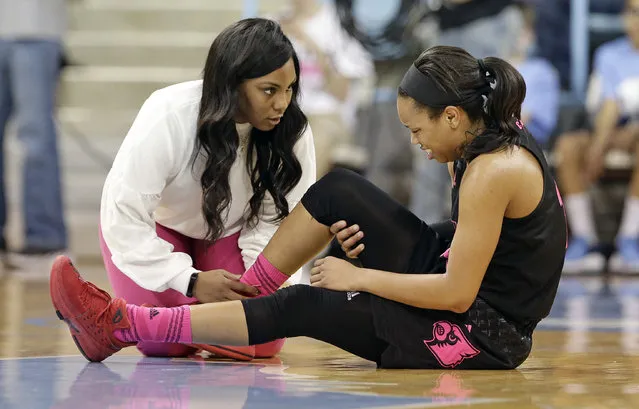 Louisville's Asia Durr, right, is attended to following an injury during the second half of an NCAA college basketball game against North Carolina in Chapel Hill, N.C., Sunday, February 18, 2018. (Photo by Gerry Broome/AP Photo)