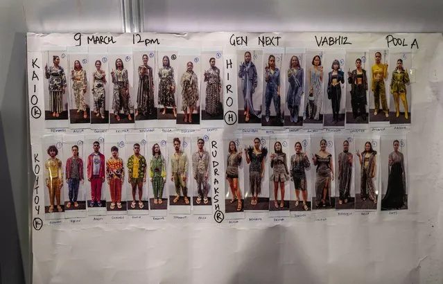 Photographs of models who will walk the ramp are pasted on a wall backstage during during Lakme Fashion Week X FDCI in Mumbai, India, Thursday, March 9, 2023. (Photo by Rafiq Maqbool/AP Photo)