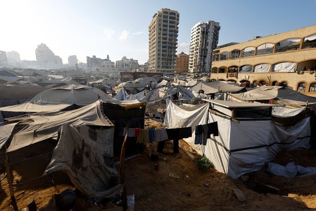 Clothes hang on a line next to the site of an overnight Israeli strike on a tent, in Gaza City, on September 8, 2025. (Photo by Mahmoud Issa/Reuters)
