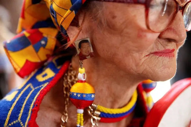 A woman wears an earring with the image of Venezuela's late President Hugo Chavez during a rally to mark the 10th anniversary of his death, in Caracas, Venezuela on March 5, 2023. (Photo by Leonardo Fernandez Viloria/Reuters)