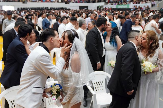 Jonathan Garay, left, kisses Fiorella Riveros during a group wedding ceremony organized by the Civil Registry to legally formalize their unions in in Asuncion, Paraguay, Saturday, October 4, 2025. (Photo by Jorge Saenz/AP Photo)