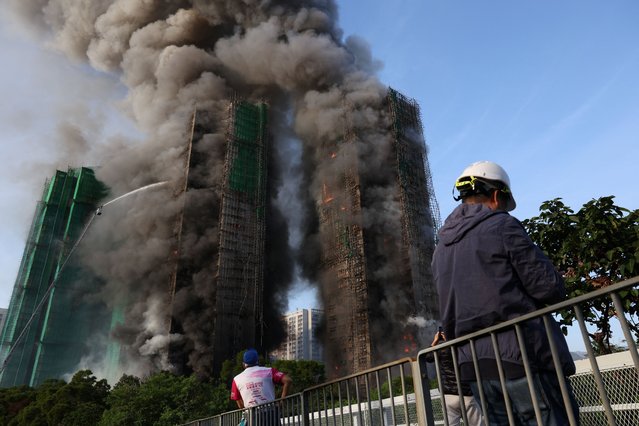 Efforts are underway to extinguish flames engulfing bamboo scaffolding across multiple buildings at the Wang Fuk Court housing estate in Tai Po, Hong Kong, China, on November 26, 2025. (Photo by Tyrone Siu/Reuters)
