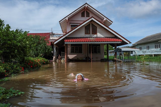 Nichakorn Sri-ampai, 5, swims through a flooded area outside her home, affected by heavy rainfall and overflowing rivers, with Ayutthaya as one of the worst-hit areas, at Sena district, in Ayutthaya province, Thailand, on October 8, 2025. (Photo by Chalinee Thirasupa/Reuters)