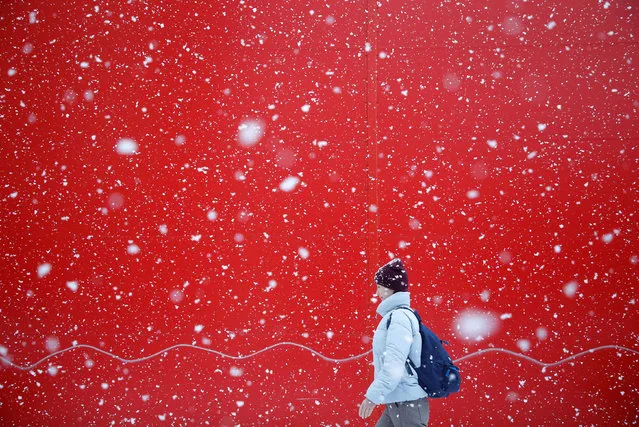 A pedestrian walks along a street during heavy snowfall in Stavropol, Russia on January 29, 2021. (Photo by Eduard Korniyenko/Reuters)