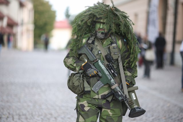 A man in military costume participates in the 18th edition of the historical event “Fields of Glory” in Niepolomice, Poland, 29 September 2024. The 'Fields of Glory' stands as one of the largest events in Poland, attracting a vast audience of history and military enthusiasts. The main theme for this year focuses on the late Middle Ages, characterized by grand castles, armored knights, and a vibrant cultural and commercial landscape. Additionally, this year's event will honor the 80th anniversary of the Battle of Monte Cassino, the landing at Arnhem, and the Warsaw Uprising. (Photo by Lukasz Gagulski/EPA/EFE)