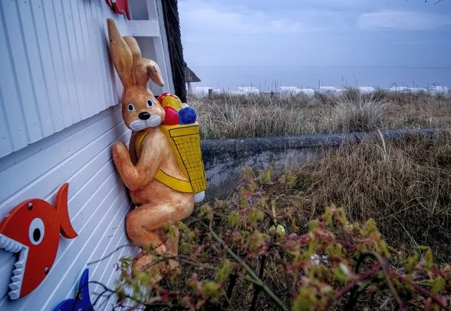A plastic Easter bunny is fixed at a beach booth at the Baltic Sea in Haffkrug, northern Germany, Thursday, April 15, 2022. (Photo by Michael Probst/AP Photo)