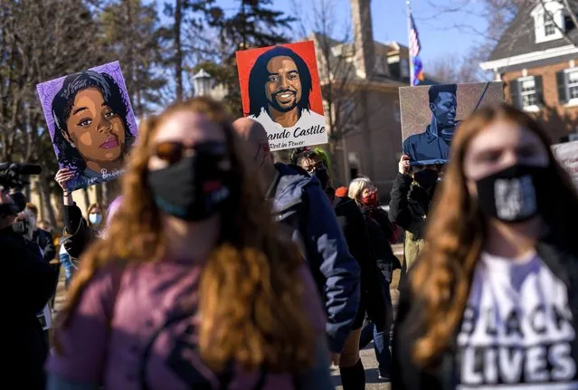 People hold portraits of Breonna Taylor, Philando Castile, and Elijah McClain during a protest demonstration outside the Governors Mansion on March 6, 2021 in St. Paul, Minnesota. A number of protests are scheduled in the days before jury selection is set to begin in the trial of former Minneapolis Police Officer Derek Chauvin on Monday, March 8. (Photo by Stephen Maturen/Getty Images)