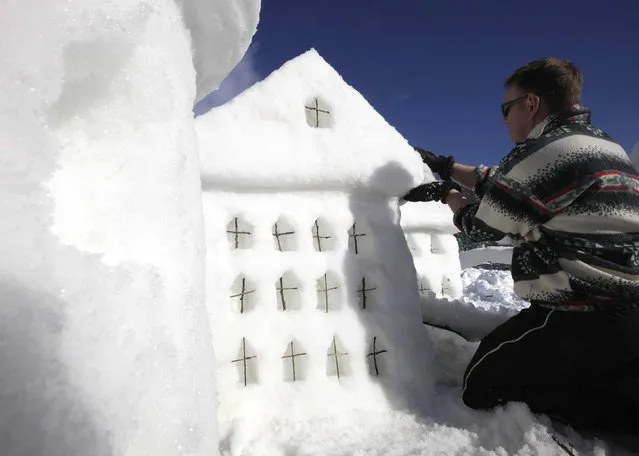 A participant makes a snow sculpture for a competition during a snow festival called “King Matjaz's Castles” in Crna na Koroskem January 31, 2015. (Photo by Srdjan Zivulovic/Reuters)