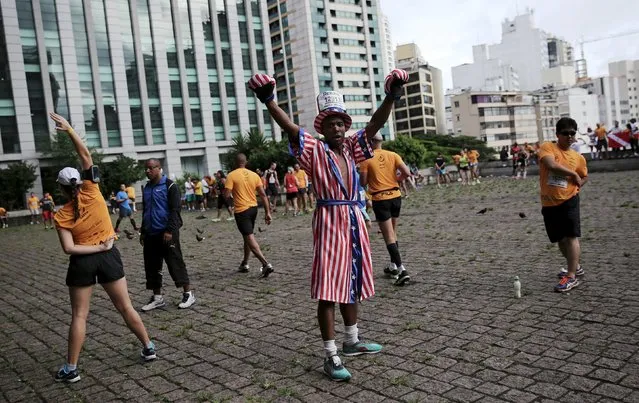 A runner dressed as Apollo Creed, a fictional character from the Rocky films, gestures before the annual "Sao Silvestre Run" (Saint Silvester Road Race), an international race through the streets of Sao Paulo, Brazil, December 31, 2015. (Photo by Nacho Doce/Reuters)