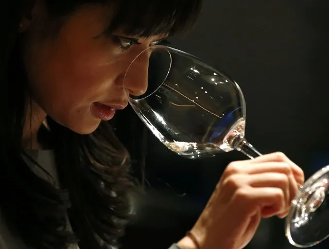 Ayana Misawa, chief winemaker of Grace Wine, smells a glass of wine at a restaurant in Tokyo January 17, 2015. Making wine comes naturally to Misawa, having spent her childhood in vineyards watching her father and grandfather nurture cherished “koshu” grapes, a unique Japanese variety known for its fresh and fruity overtones. Misawa and other winemakers in the wine hub of Yamanashi Prefecture are set on matching the success of Japan's automakers and whisky distillers, which have taken the world by storm. (Photo by Toru Hanai/Reuters)