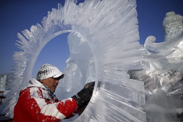 A worker polishes an ice sculpture ahead of the Harbin International Ice and Snow Festival in the northern city of Harbin, Heilongjiang province, January 4, 2016. (Photo by Aly Song/Reuters)