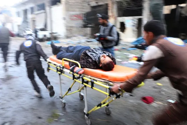 Search and rescue team members hospitalize a wounded civilian at the site of blast after Assad Regime's strike over civilians in residential areas of Jub Al Quba neighborhood of Aleppo, Syria on November 30, 2016. At least 45 civilians including children and women, killed during the attack. (Photo by Jawad al Rifai/Anadolu Agency/Getty Images)