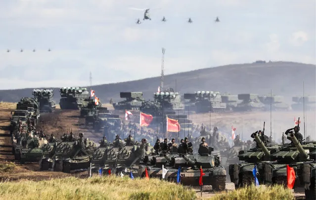 Chinese tanks roll during a military exercises on training ground “Tsugol”, about 250 kilometers (156 miles ) south-east of the city of Chita during the military exercises Vostok 2018 in Eastern Siberia, Russia, Thursday, September 13, 2018. The weeklong Vostok (East) 2018 maneuvers launched Tuesday span vast expanses of Siberia and the Far East, the Arctic and the Pacific Oceans. They involve nearly 300,000 Russian troops along with 1,000 Russian aircraft and 36,000 tanks and other combat vehicles. (Photo by Vyacheslav Prokofyev/TASS)