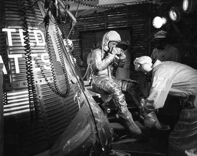 In this February 20, 1962, file photo, astronaut John Glenn sits next to the Friendship 7 space capsule atop an Atlas rocket at Cape Canaveral, Fla., during preparations for his flight which made him the first American to orbit the Earth. (Photo by AP Photo)