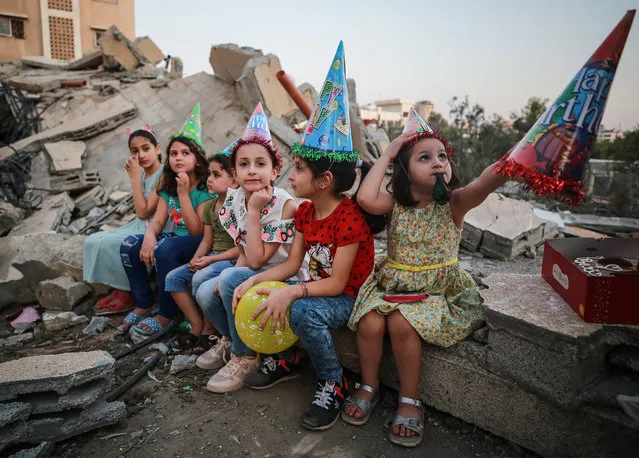 Sabih family and friends of 13 year old Mahmoud Sabih celebrate his birthday near the debris of their former house, collapsed after Israeli attacks began on May 10 in Gaza Strip, Gaza on May 25, 2021. (Photo by Mustafa Hassona/Anadolu Agency via Getty Images)