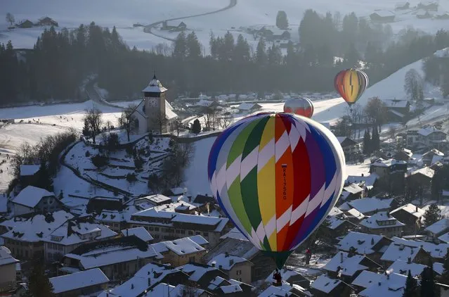 Balloons fly during the 38th International Hot Air Balloon Week in Chateau-d'Oex, Switzerland January 23, 2016. (Photo by Denis Balibouse/Reuters)