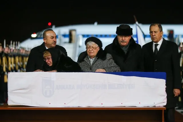 Andrei Karlov' s widow Marina (L front) and mother Maria (C) weep over the body of Russia' s Ambassador to Turkey, delivered to Vnukovo International Airport by a charter flight. Karlov was shot dead on December 19, 2016 in Ankara' s Contemporary Art Centre. Pictured in this image are Turkey' s Foreign Minister Mevlut Cavusoglu (L back) and his Russian counterpart Sergei Lavrov (R). (Photo by Valery Sharifulin/TASS)