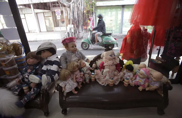 In this Friday, January 29, 2016 photo, a collection of “child angel” dolls are displayed at the clothing store of their owner Supavadee Tapmalai in Bangkok, Thailand, Friday, Jan. 28 , 2016. (Photo by Sakchai Lalit/AP Photo)