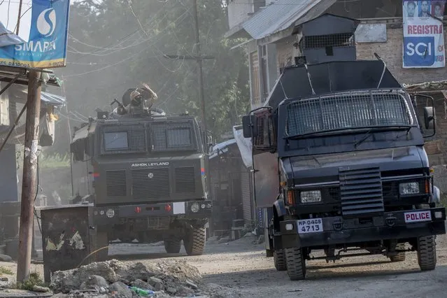 Indian policemen in armored vehicles arrive near the site of a gunfight in Pulwama, south of Srinagar, Indian controlled Kashmir, Friday, July 2, 2021. Five suspected rebels and an army soldier were killed in a gunfight in Indian-controlled Kashmir on Friday, officials said, as violence in the disputed region has increased in recent weeks. (Photo by Dar Yasin/AP Photo)