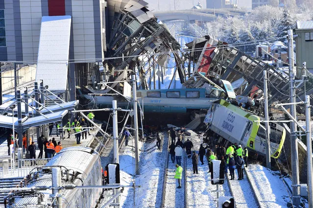 Members of rescue services work at the scene of a train accident in Ankara, Turkey, Thursday, December 13, 2018. A high-speed train hit a railway engine and crashed into a pedestrian overpass at a station in the Turkish capital Ankara on Thursday, killing more than 5 people and injuring more than 40 others, officials and news reports said. (Photo by Depo Photos/Rex Features/Shutterstock)