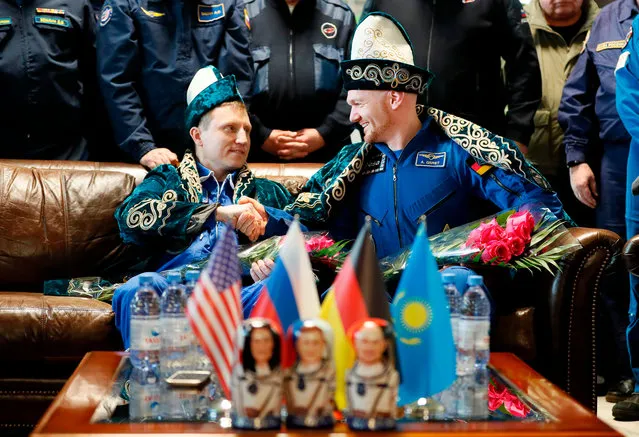 Russian cosmonaut Sergey Prokopyev of Roscosmos and German astronaut Alexander Gerst of the European Space Agency dressed in Kazakh national costumes attend a press conference at the airport of Dzhezkazgan (Zhezkazgan), Kazakhstan, on December 20, 2018. Three astronauts landed back on Earth on December 20, 2018 after a troubled stint on the ISS marred by an air leak and the failure of a rocket set to bring new crew members. (Photo by Shamil Zhumatov/AFP Photo)