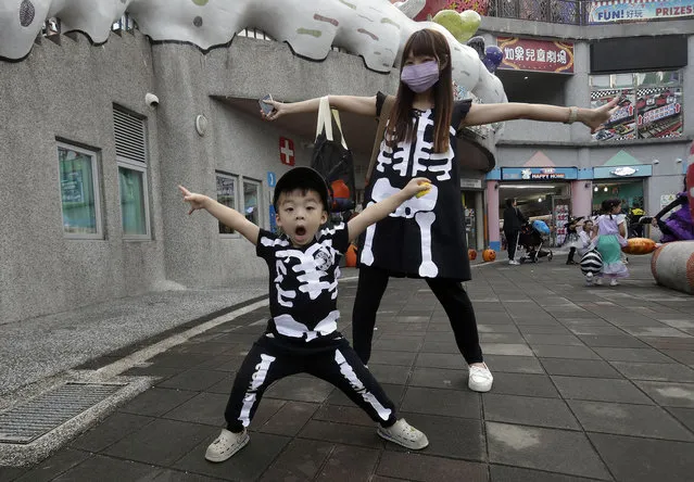 Mother and son in disguise attend a Halloween celebration at Taipei Children's Amusement Park in Taipei, Taiwan, Sunday, October 29, 2023. (Photo by Chiang Ying-ying/AP Photo)