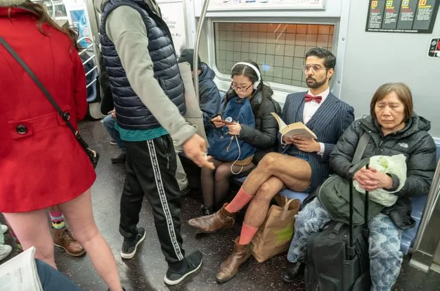 A man rides the F subway line during the 18th annual No Pants subway ride on January 13, 2019 in New York City. 24 cities participate in the annual event arranged by Improv Everywhere a New York city based comedy collective. (Photo by David “Dee” Delgado/Getty Images)