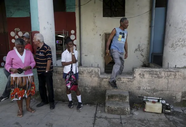 Eduardo Hernandez (R), 52, a member of a fumigation brigade leaves a house after inspects in Havana February 2, 2016. Cuba conducts regular fumigation inside homes to check the spread of dengue, a virus transmitted by the Aedes aegypti mosquito that causes a fever which can be deadly. The same mosquito can also spread the Zika virus, although the Cuban government says there have been no reported cases of the disease in the country. (Photo by Enrique de la Osa/Reuters)