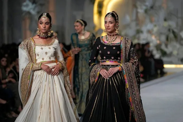 Models present creations from designer Fahad Hussayn during a fashion show of Bridal Couture Week in Lahore, Pakistan, Friday, December 15, 2023. (Photo by K.M. Chaudary/AP Photo)