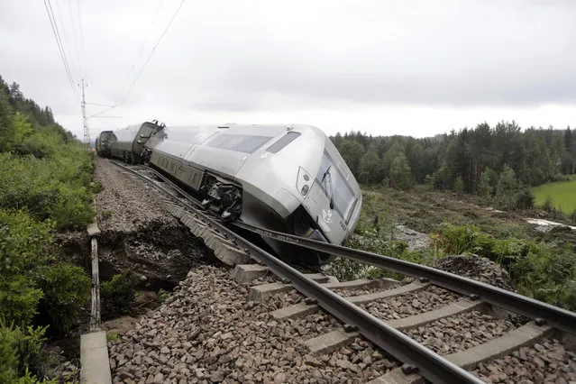 A passenger train carrying 120 passengers derailed between Iggesund and Hudiksvall in Sweden, on August 07, 2023. Three people have been taken to hospital, according to the police. The train was on its way from Stockholm to Sundsvall when the front two of a total of four carriages derailed just south of Hudiksvall. The embankment was undermined as a result of heavy rain. (Photo by Mats Andersson/TT News Agency vía AP Photo)