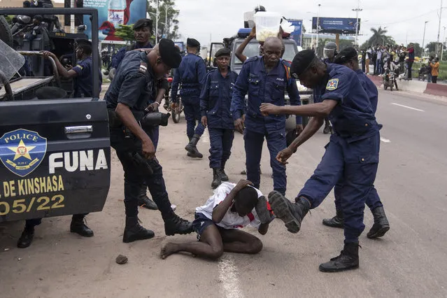 Security forces assault a supporter of presidential candidate Martin Fayulu during clashes outside his party's headquarters, in Kinshasa, Democratic Republic of the Congo, Wednesday, December 27, 2023. Fayulu, a main opposition candidate accused police of using live bullets to break up a protest Wednesday in Congo's capital, as demonstrators demanded a re-do for last week's presidential election. Fayulu is one of five opposition candidates who say the election should be rerun and question its credibility. Some rights groups and international observers also have questioned the vote. (Photo by Mosa'ab Elshamy/AP Photo)