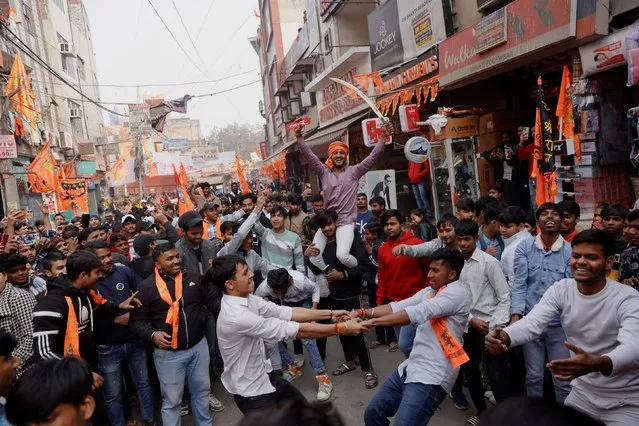 People celebrate the opening of the grand temple of the Hindu god Lord Ram in the northern town of Ayodhya, in a street in New Delhi, India, on January 22, 2024. (Photo by Anushree Fadnavis/Reuters)