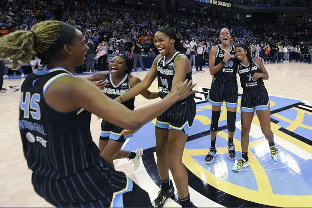 Chicago Sky players celebrate after defeating the Connecticut Sun 79-69 in Game 4 of a WNBA semifinal playoff basketball game Wednesday, October 6, 2021, in Chicago. (Photo by Paul Beaty/AP Photo)